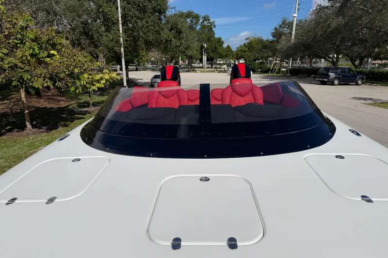 Yacht Photos Pics 2022 Doug Wright 320 boat with red seats and sleek design, parked outdoors.