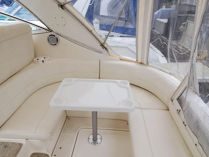  Yacht Photos Pics 2004 Cruisers Yachts 340 Express interior with white seating and table.