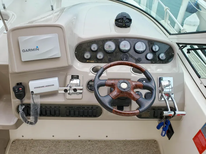  Yacht Photos Pics 2004 Cruisers Yachts 340 Express helm with Garmin navigation and wood-accented steering wheel.