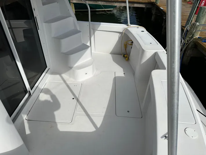 Chapter 2 Yacht Photos Pics 1998 Mainship 350 Trawler deck with white stairs and seating area.