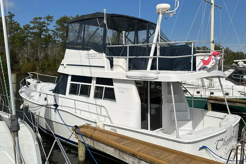 Chapter 2 Yacht Photos Pics 1998 Mainship 350 Trawler docked, featuring spacious deck and covered flybridge.
