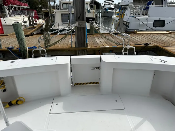 Chapter 2 Yacht Photos Pics 1998 Mainship 350 Trawler docked at marina, showcasing spacious deck and surrounding boats.