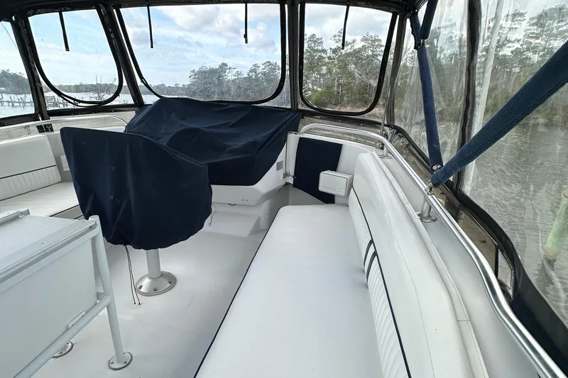 Chapter 2 Yacht Photos Pics 1998 Mainship 350 Trawler interior with covered seating and panoramic windows.