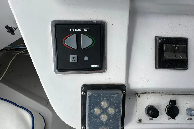 Chapter 2 Yacht Photos Pics Control panel of a 1998 Mainship 350 Trawler, featuring thruster and switch controls.