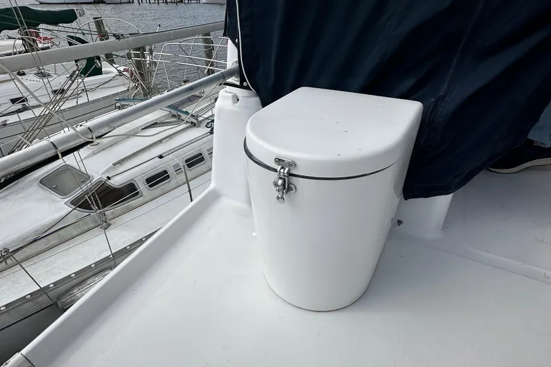 Chapter 2 Yacht Photos Pics 1998 Mainship 350 Trawler deck with secured storage compartment, docked at marina.