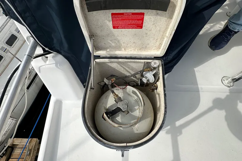 Chapter 2 Yacht Photos Pics Open compartment on 1998 Mainship 350 Trawler deck, revealing mechanical components.