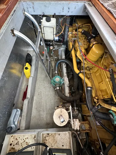 Chapter 2 Yacht Photos Pics Engine compartment of a 1998 Mainship 350 Trawler, showcasing mechanical components and wiring.