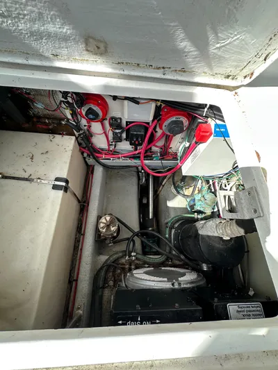 Chapter 2 Yacht Photos Pics Engine compartment of a 1998 Mainship 350 Trawler, showing wiring and mechanical components.