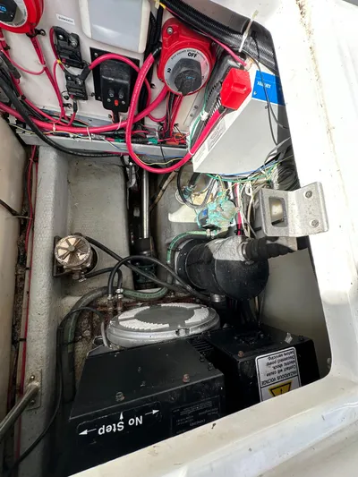 Chapter 2 Yacht Photos Pics Engine compartment of a 1998 Mainship 350 Trawler with wiring and components visible.