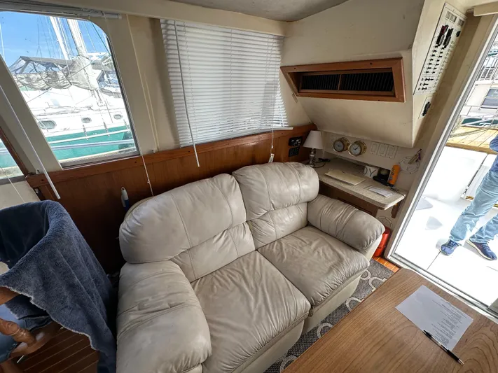 Chapter 2 Yacht Photos Pics Interior of 1998 Mainship 350 Trawler with beige sofa and navigation station.