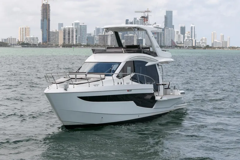  Yacht Photos Pics 2020 Galeon 500 Fly yacht cruising near city skyline.