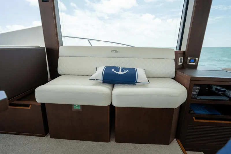  Yacht Photos Pics Luxurious interior of 2020 Galeon 500 Fly yacht with white seating and nautical pillow.