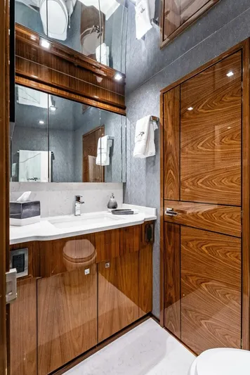 Rachel Anne Yacht Photos Pics Luxurious bathroom in 2022 Viking 80 yacht with sleek wood finishes and modern fixtures.