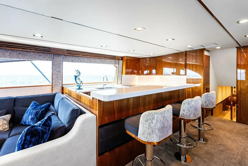 Rachel Anne Yacht Photos Pics Luxurious interior of 2022 Viking 80 yacht with modern kitchen and seating area.