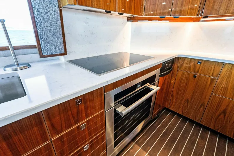 Rachel Anne Yacht Photos Pics Modern kitchen in 2022 Viking 80 yacht with sleek wood cabinetry and stainless steel appliances.