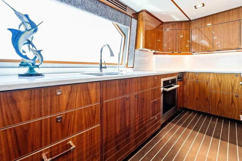 Rachel Anne Yacht Photos Pics Luxurious kitchen in 2022 Viking 80 yacht with wooden cabinetry and modern appliances.