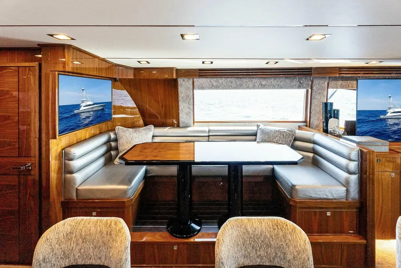 Rachel Anne Yacht Photos Pics Luxurious interior of 2022 Viking 80 yacht with elegant seating and wooden finishes.