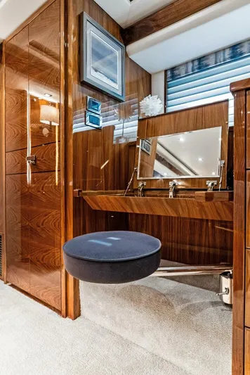 Rachel Anne Yacht Photos Pics Luxurious interior of 2022 Viking 80 yacht with elegant wood finish and vanity area.