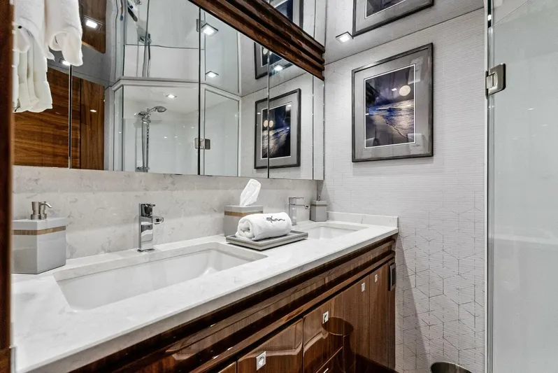 Rachel Anne Yacht Photos Pics Luxurious bathroom in 2022 Viking 80 yacht with modern fixtures and elegant decor.