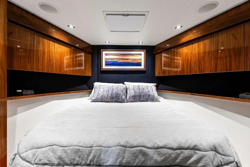 Rachel Anne Yacht Photos Pics Luxurious bedroom interior of 2022 Viking 80 yacht with elegant wood paneling.