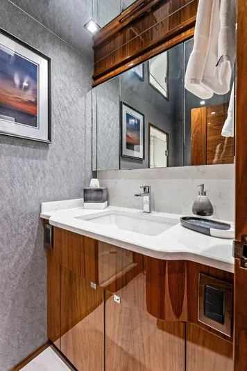 Rachel Anne Yacht Photos Pics Luxurious bathroom in 2022 Viking 80 yacht with modern fixtures and elegant wood cabinetry.