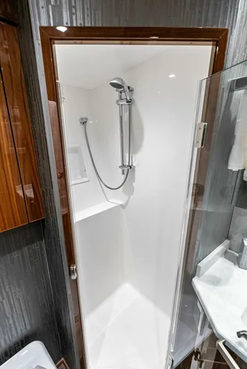 Rachel Anne Yacht Photos Pics Compact shower in 2022 Viking 80 yacht with sleek design and modern fixtures.