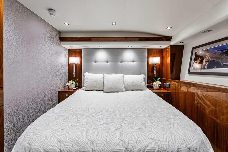 Rachel Anne Yacht Photos Pics Luxurious bedroom interior on 2022 Viking 80 yacht, featuring elegant bedding and modern lighting.