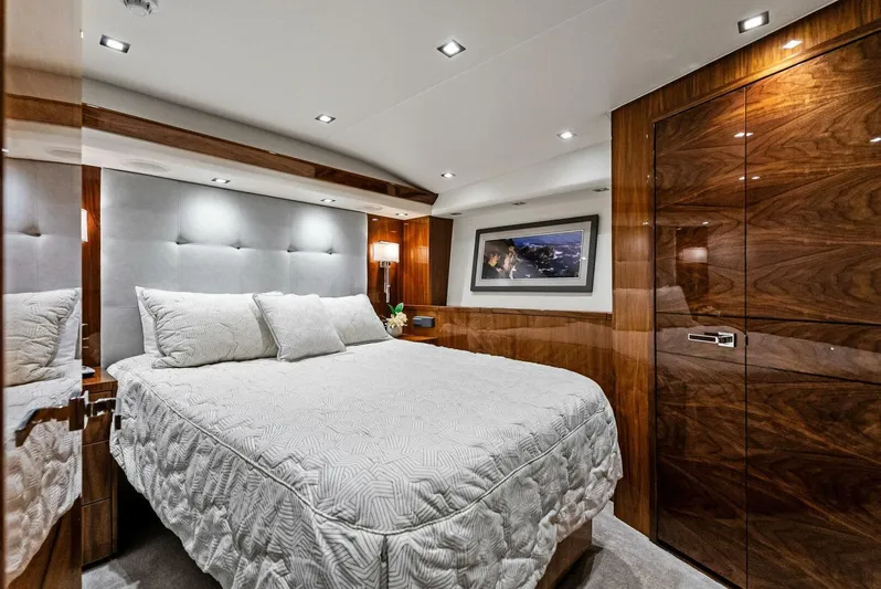 Rachel Anne Yacht Photos Pics Luxurious bedroom interior of 2022 Viking 80 yacht with elegant wood paneling and modern lighting.