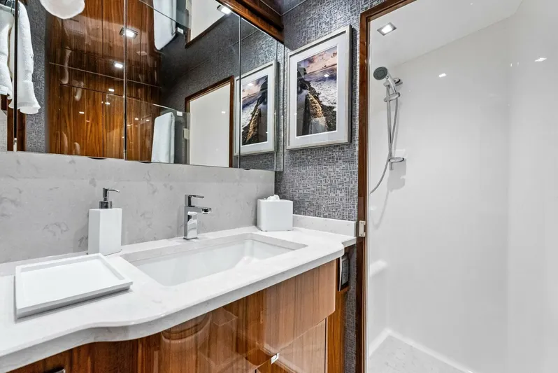 Rachel Anne Yacht Photos Pics Luxurious bathroom in 2022 Viking 80 yacht with modern fixtures and elegant design.