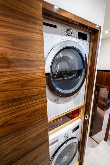 Rachel Anne Yacht Photos Pics Stacked washer and dryer in wooden cabinet on Viking 80 yacht, 2022 model.