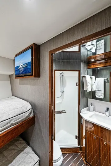 Rachel Anne Yacht Photos Pics 2022 Viking 80 yacht interior with bunk beds and modern bathroom.