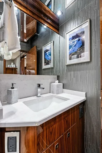 Rachel Anne Yacht Photos Pics Luxurious bathroom in 2022 Viking 80 yacht with modern fixtures and elegant decor.