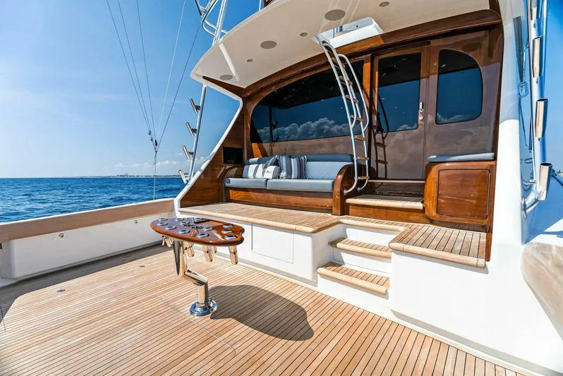 Rachel Anne Yacht Photos Pics Luxurious 2022 Viking 80 yacht deck with wooden seating and ocean view.