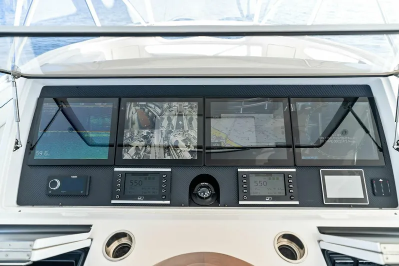 Rachel Anne Yacht Photos Pics Control panel of 2022 Viking 80 yacht with multiple navigation screens and instruments.
