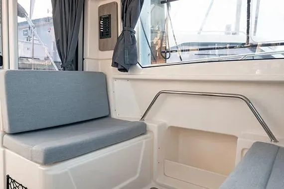  Yacht Photos Pics Interior of 2026 Trophy T25EX EXPLORER OB boat with cushioned seating and windows.