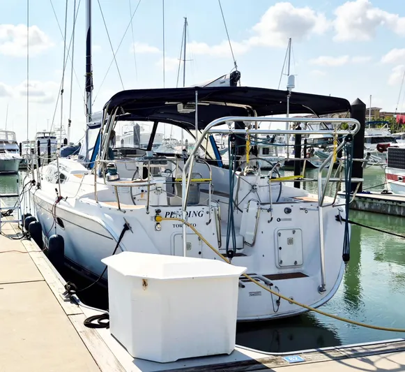 Pending Yacht Photos Pics 2012 Hunter 50 Aft Cockpit yacht docked at marina under sunny skies.