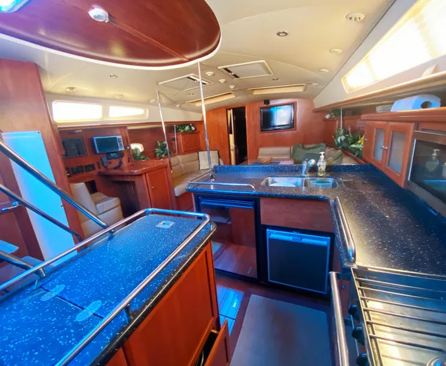 Pending Yacht Photos Pics Luxurious 2012 Hunter 50 Aft Cockpit yacht interior with modern kitchen and seating area.