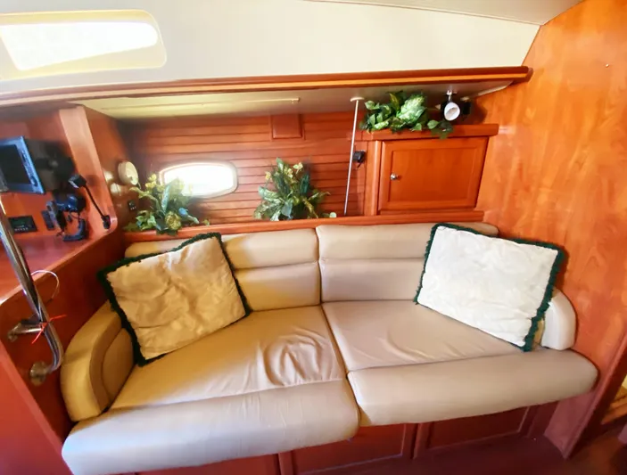 Pending Yacht Photos Pics Luxurious interior of 2012 Hunter 50 Aft Cockpit yacht with beige sofa and wooden cabinetry.