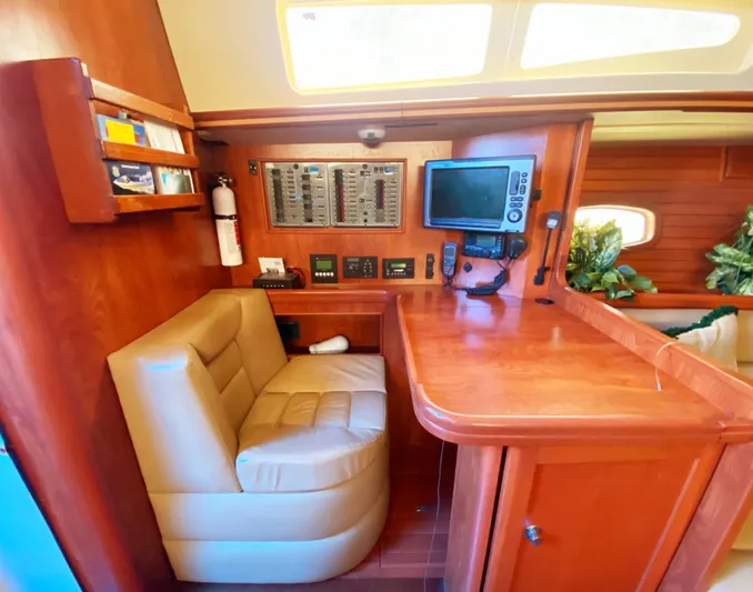 Pending Yacht Photos Pics Luxurious 2012 Hunter 50 Aft Cockpit interior with navigation station and plush seating.