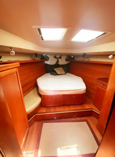 Pending Yacht Photos Pics 2012 Hunter 50 Aft Cockpit interior cabin with bed, wooden finish, and overhead skylights.