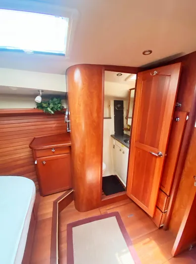 Pending Yacht Photos Pics 2012 Hunter 50 Aft Cockpit interior with wood finish, featuring a cozy cabin and kitchenette.
