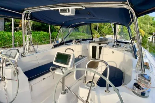 Pending Yacht Photos Pics 2012 Hunter 50 Aft Cockpit sailboat with modern navigation equipment and blue canopy.