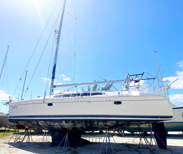 Pending Yacht Photos Pics 2012 Hunter 50 Aft Cockpit sailboat on stands under clear blue sky.