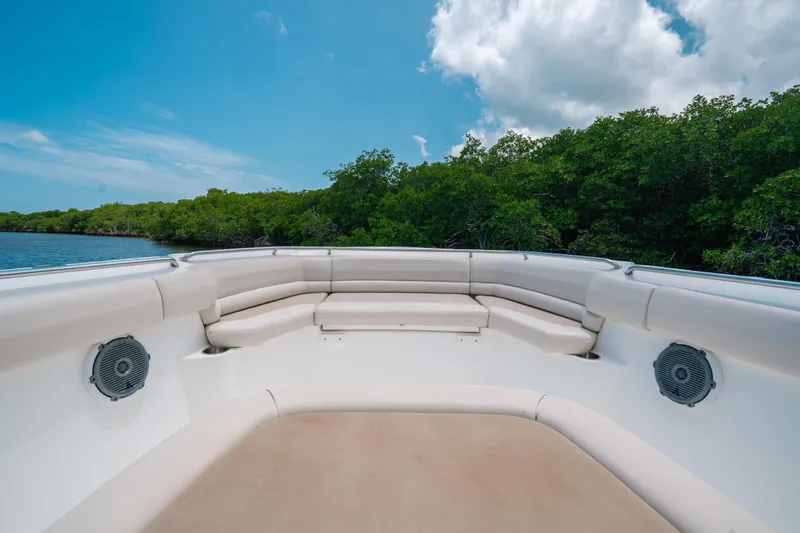  Yacht Photos Pics 2019 Boston Whaler 330 Outrage boat interior with cushioned seating and speakers, under blue sky.
