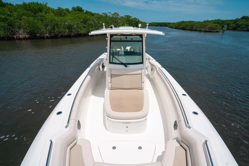  Yacht Photos Pics 2019 Boston Whaler 330 Outrage boat cruising on a serene river.