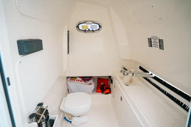  Yacht Photos Pics 2019 Boston Whaler 330 Outrage cabin interior with toilet and storage space.