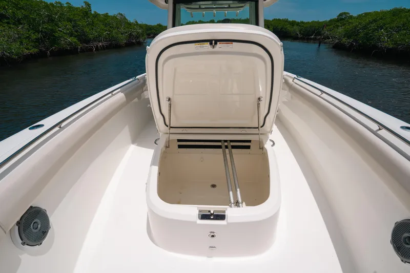  Yacht Photos Pics 2019 Boston Whaler 330 Outrage boat with open storage compartment on deck.