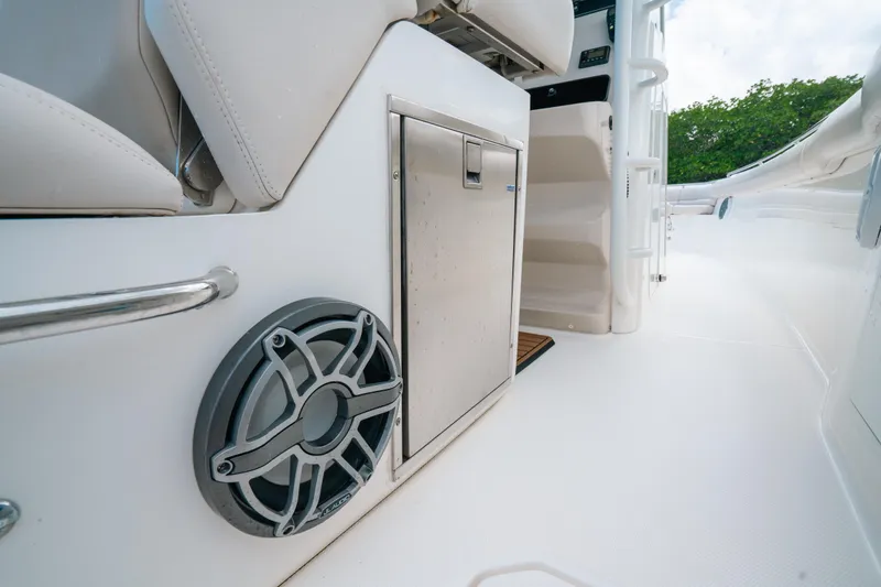  Yacht Photos Pics 2019 Boston Whaler 330 Outrage interior with speaker and storage compartment.