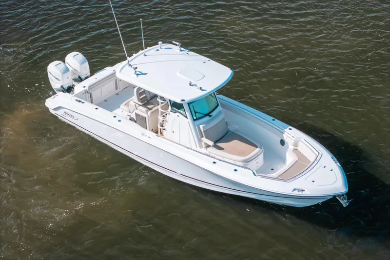  Yacht Photos Pics 2019 Boston Whaler 330 Outrage boat on water, aerial view.