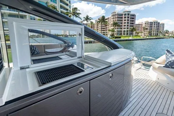 Endless Summer Yacht Photos Pics Luxury 2020 Princess V55 yacht with sleek outdoor kitchen and waterfront view.